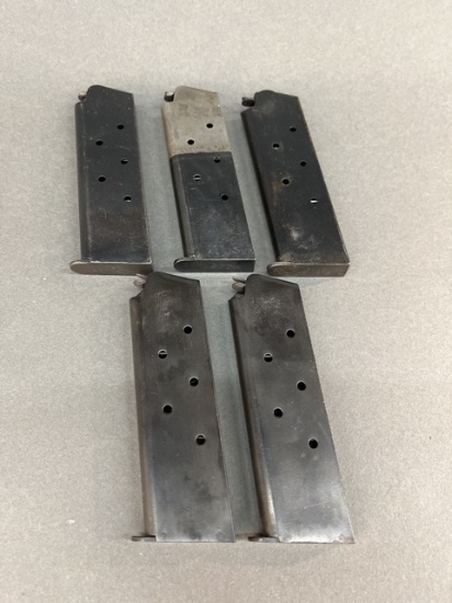 Five Colt marked 1911 45ACP magazines.