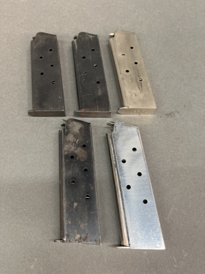 Five Colt marked 1911 45ACP magazines.