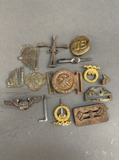 Assorted military buckles and pins.