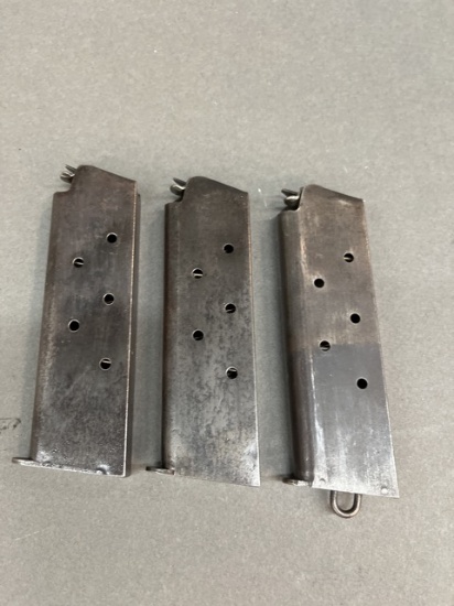 Three M1911 pistol magazines.