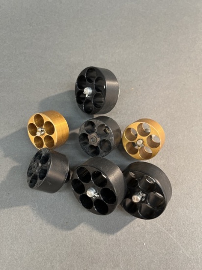 Seven revolver speed loaders.