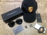 Porsche-branded baseball cap, sunglasses, cuff links and key fob