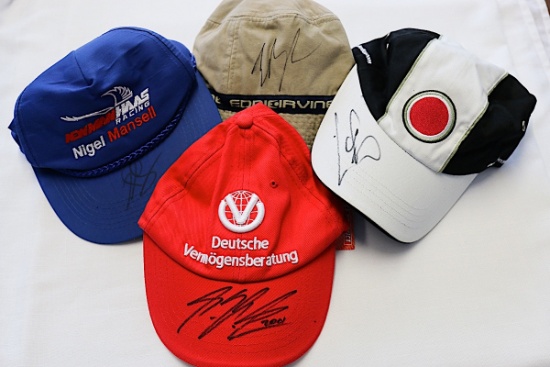 Four F1 driver-signed F1 caps