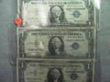 Three old Silver Certificate Dollar Bills (in individual sleeves) - 1935 & 1957