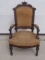 Antique Carved Wood Upholstered Arm Chair – Stands Appx 42 ½”   Front edge 24” W  20” Deep