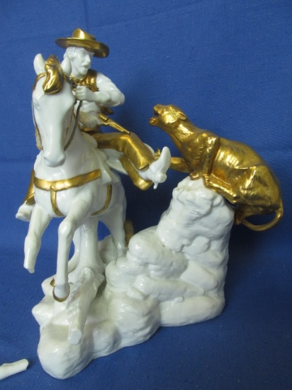 White & Gilded Ceramic Sculpture of a Cowboy on Horsesback taking aim at a Puma – Marked Lucas