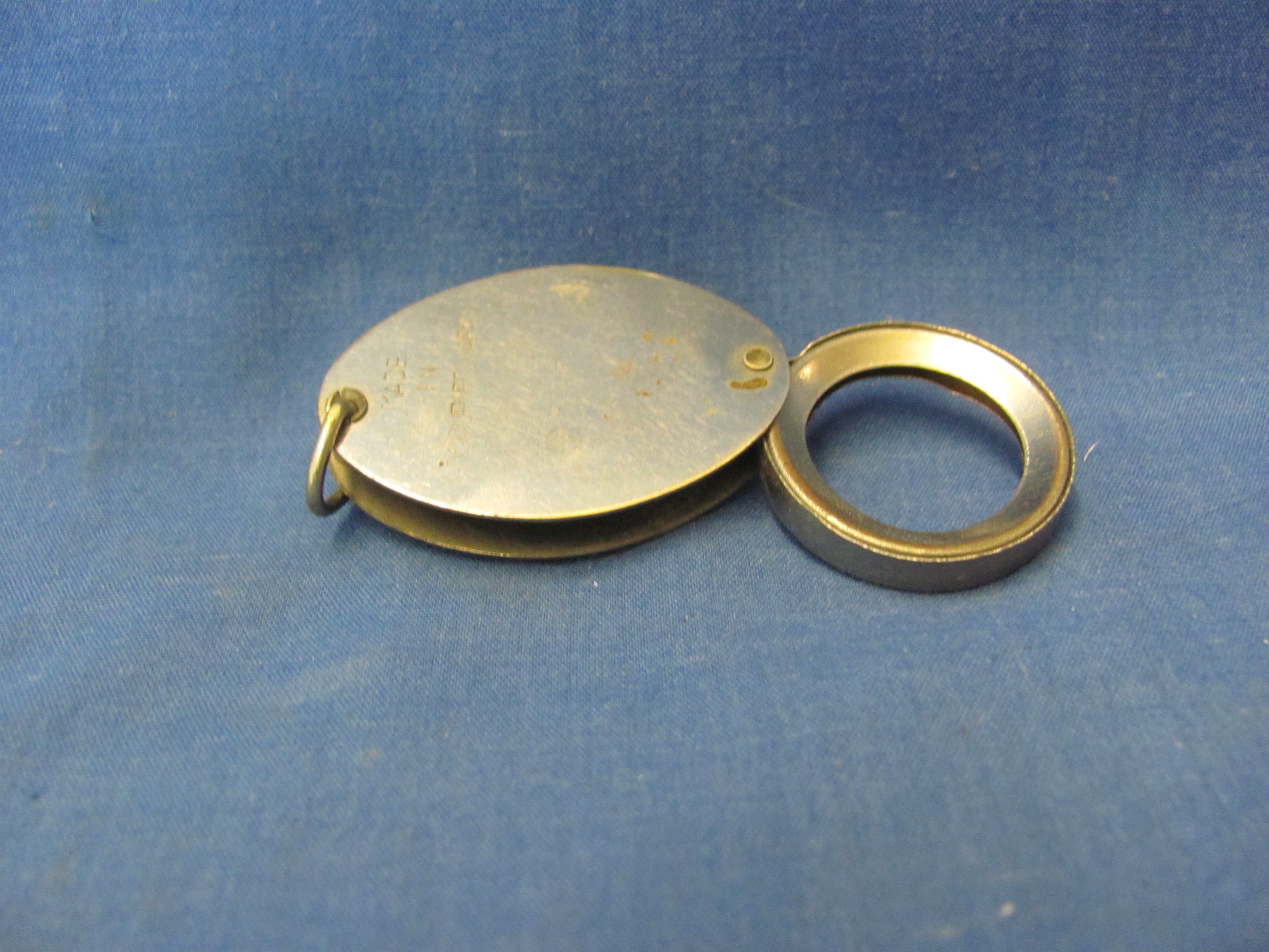 Sold at Auction: A SMALL BRASS MAGNIFYING GLASS on a stand.