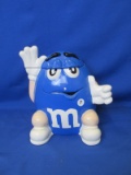 Blue M&M Cookie Jar 9”L x 7”W x 9 ¾”H – Some Paint Loss Please Consult Pictures -