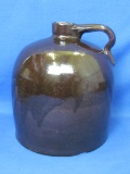 Brown Stoneware Jug - - 9” tall – Chip on bottom – Wear around rim