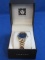 Ann Klein Wristwatch – Goldtone with Black Face – Running – Clasp Band – In Case
