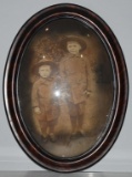 WWI OVAL FRAMED PHOTOGRAPH -2 CHILDREN IN UNIFORMS