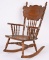 CHILD’S OAK PRESS BACK ROCKING CHAIR.