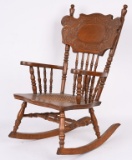 CHILD’S OAK PRESS BACK ROCKING CHAIR.