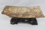 A carved segment of Woolly Mammoth tusk depicting six figures