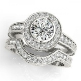 14KT White Gold 2 ct Halo Engagement & Wedding Ring Set with J-L color and SI3/I1 clarity diamonds.