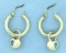 Hoop Earrings With Dangling Sky Blue Topaz Hearts In 14k Yellow Gold