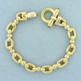 Designer Cable Link Bracelet With Ruby Clasp In 18k Yellow Gold