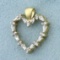 Round And Baguette Diamond Heart Pendant In 14k Yellow And White Gold