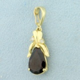 Garnet And Diamond Pendant In 14k Yellow Gold