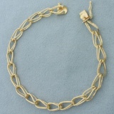 Double Tapered Loop Link Charm Bracelet In 14k Yellow Gold