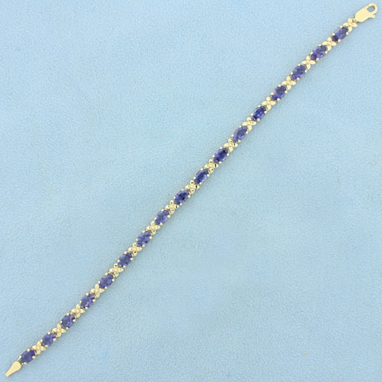 Aaa Tanzanite Flower Design Line Bracelet In 14k Yellow Gold