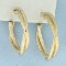 Diamond Cut Satin Finish Twisting Hoop Earrings In 14k Yellow Gold