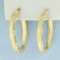 Diamond Cut Oval Hoop Earrings In 14k Yellow Gold