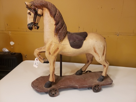 Antique wooden toy horse on wheels