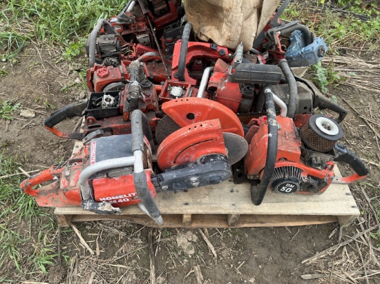 Pile of chainsaw parts and 2 cut off saws