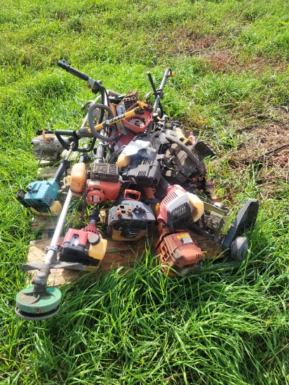 pallet of parts weedeaters and chainsaws