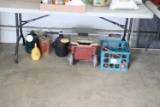 Assortment of watering cans, yard tools, and misc.