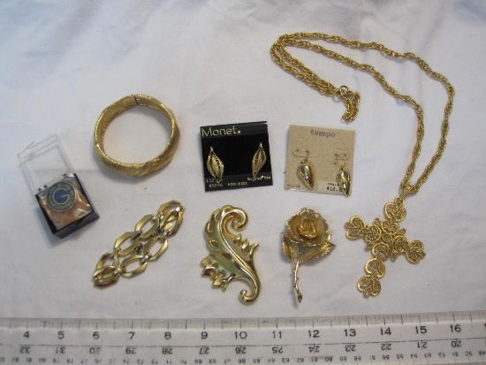 Lot of goldtone costume jewelry including earrings, necklaces, and 10 year Goebel Collector's Club
