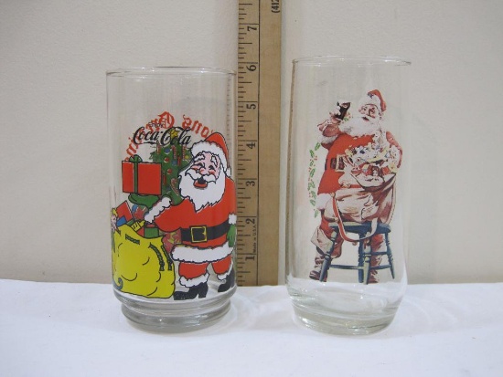 Two Coca-Cola Christmas Glasses, one marked 93761 three of three Series II and one marked McCrory