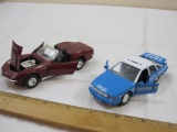 Two Diecast Model Cars including NYPD Police Chevrolet Caprice (Welly no. 9052) and 1969 Corvette