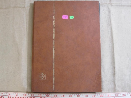 Book of assorted US stamps, foreign stamps and first day of issue envelopes