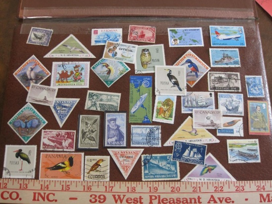 Lot of approximately three dozen postage stamps from various countries, some cancelled, two in