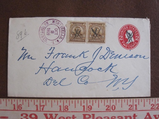 One stamped 1909 2 cent envelope with cancelled red 2 cent stamp and two 4 cent Grant postage stamps
