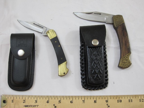 Two Folding Pocket Knives Belt Cases including one marked Pakistan and other marked Stainless China