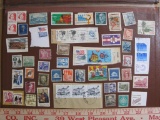 Miscellaneous lot of mostly canceled postage stamps from the US and other countries, including