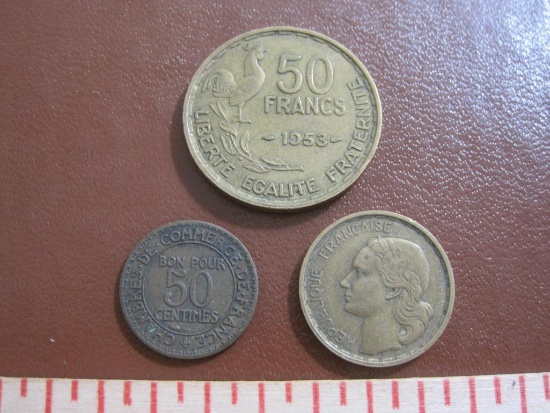 Three French coins: one 1923 50 centimes, one 1951 10 francs and one 1953 50 francs