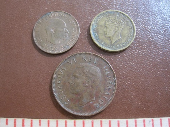 one 1938 British West Africa 6 pence, one 1964 Sierra Leone 1/2 cent and one bronze 1942 South