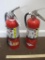 2 expired fire extinguishers, one Cosmic, one Amerex. As is