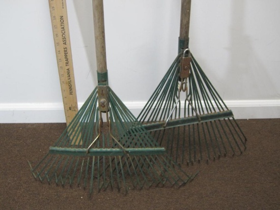 Two metal rakes with wooden handles