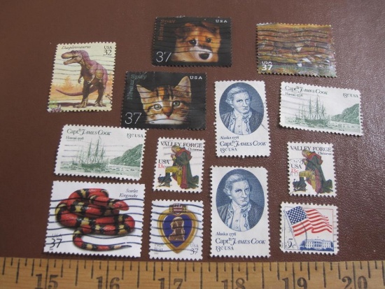 Lot of approximately ONE DOZEN cancelled US postage stamps including 1997 Daspletosaurus, 1977