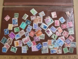 Lot of 60+ assorted cancelled foreign postage stamps from various countries inlcuding Spain,