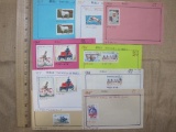 Lot of 13 unused 1960s Mali postage stamps, attached at the top to pieces of construction paper.