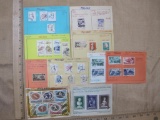 Lot of 31 mostly canceled 1956 and 1957 Poland postage stamps, attached to small sheets of paper.