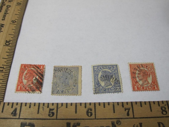 Four canceled Queensland (Australia) postage stamps including one penny and two penny