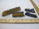 Four N Scale Train Cars including Con Cor Union Pacific Locomotive and Tanker and GM Locomotive and