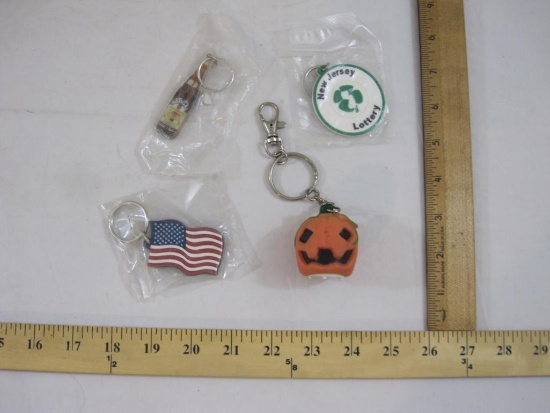 Lot of Assorted Key Chains including New Jersey Lottery, Brugal, US Flag Route 23 Auto Mall, and